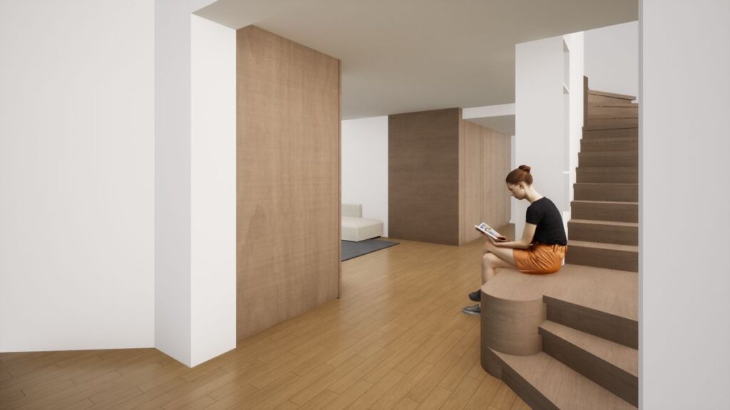 escalier en bois avec siège sur lequel lit une jeune fille dans une villa des années 30 qui fait l'objet d'une rénovation complète